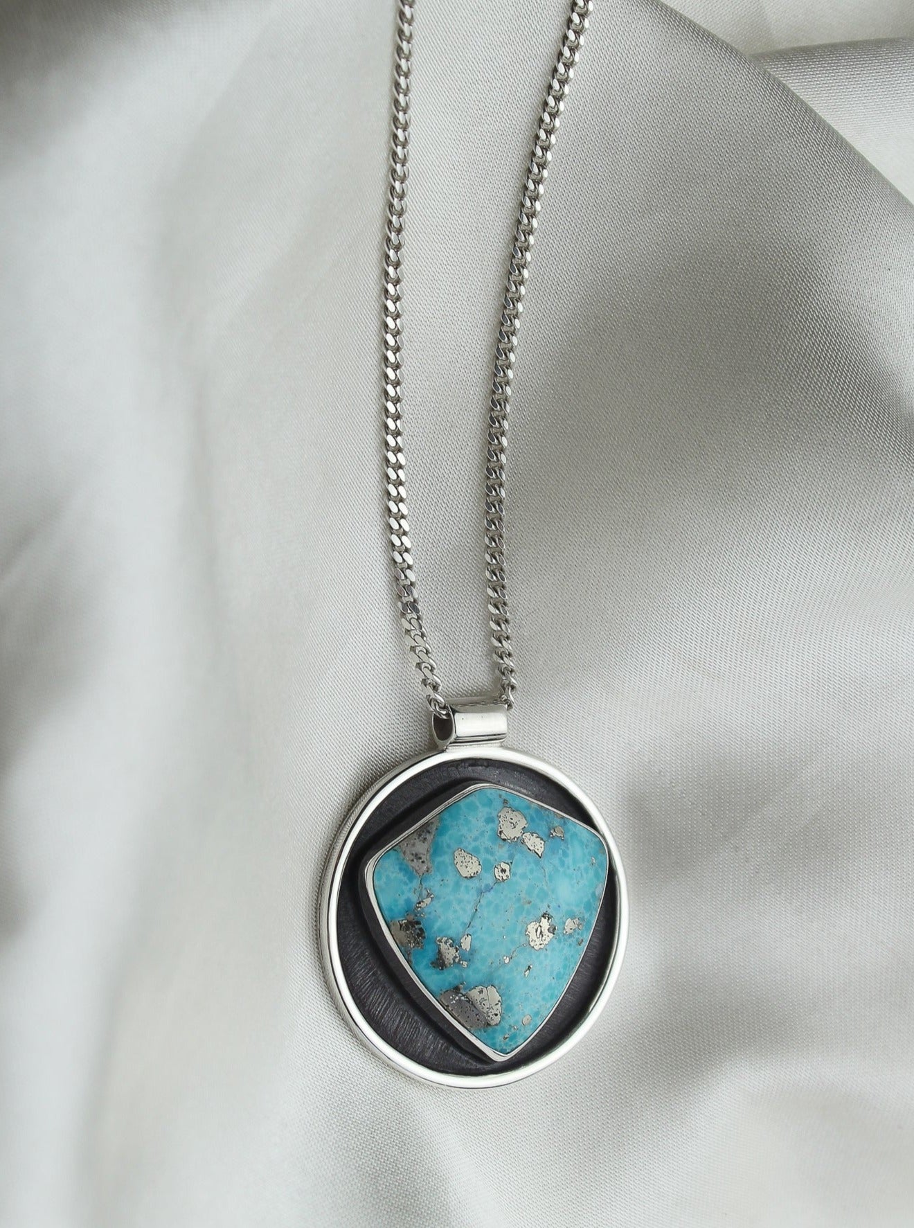 Handmade 925 sterling silver circular pendant with shield shaped white water turquoise stone with pyrite inclusions lily and William jewelry