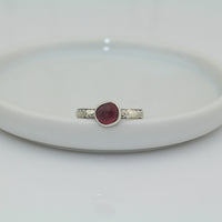 faceted pink tourmaline stone set in 999 fine silver and 925 sterling silver on a ornate pattern silver band ring size 5